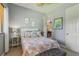 Relaxing bedroom offers neutral tones, coastal-themed decor, and a convenient doorway leading to other parts of the home at 10113 Bell Creek Dr, Riverview, FL 33569
