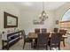 Dining room featuring a large mirror, decorative chandelier and seating for six at 10113 Bell Creek Dr, Riverview, FL 33569
