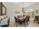 Dining room with chandelier, natural light, and seating for six offers a welcoming gathering space at 10113 Bell Creek Dr, Riverview, FL 33569