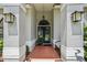 Inviting covered front entrance with a blue double door, decorative lanterns, and a tiled walkway at 10113 Bell Creek Dr, Riverview, FL 33569