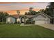 Beautiful single-story home featuring a well-manicured lawn and a three-car garage with a light gray exterior at 10113 Bell Creek Dr, Riverview, FL 33569