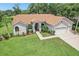 Charming single-story home with manicured lawn, garden beds, and a welcoming entrance with a brick walkway at 10113 Bell Creek Dr, Riverview, FL 33569