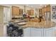 Spacious kitchen features an island, stainless steel appliances, granite countertops, and custom cabinetry at 10113 Bell Creek Dr, Riverview, FL 33569