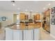 The kitchen features an island with granite countertops, custom cabinets, and stainless steel appliances at 10113 Bell Creek Dr, Riverview, FL 33569