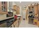 Gourmet kitchen features stainless steel appliances, custom cabinetry, and a wine fridge at 10113 Bell Creek Dr, Riverview, FL 33569