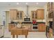 Well-lit kitchen features wood cabinets, stainless steel appliances, and a central butcher block island at 10113 Bell Creek Dr, Riverview, FL 33569