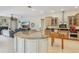 Spacious kitchen with granite countertops, an island, and stainless steel appliances open to the living room at 10113 Bell Creek Dr, Riverview, FL 33569
