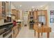 Gourmet kitchen with stainless steel appliances, custom cabinetry, black countertops, and a wine fridge at 10113 Bell Creek Dr, Riverview, FL 33569
