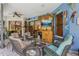 Inviting lanai with cozy seating, colorful decor, and a view of the lush backyard and pool at 10113 Bell Creek Dr, Riverview, FL 33569