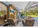 Covered lanai featuring comfortable seating, tropical-themed decor, and serene views of the outdoors at 10113 Bell Creek Dr, Riverview, FL 33569