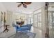 Open-concept living room with tile flooring, view of dining room, and double doors leading to the outdoors at 10113 Bell Creek Dr, Riverview, FL 33569