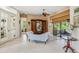 Elegant living room featuring tile floors, ceiling fan, and sliding glass doors to outdoor living area at 10113 Bell Creek Dr, Riverview, FL 33569