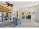 Open-concept living room with tile flooring, a ceiling fan, and access to the kitchen and dining area at 10113 Bell Creek Dr, Riverview, FL 33569