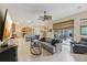 Open-concept living room featuring neutral tones, access to patio, and seamless flow to kitchen at 10113 Bell Creek Dr, Riverview, FL 33569