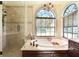 A naturally lit main bathroom featuring a soaking tub and walk in shower at 10113 Bell Creek Dr, Riverview, FL 33569