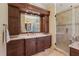 A well lit main bathroom with dual vanities, and a walk in shower at 10113 Bell Creek Dr, Riverview, FL 33569