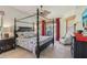 This bedroom features a four poster bed, an armchair, and natural lighting at 10113 Bell Creek Dr, Riverview, FL 33569