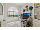 Bright office space with large window, built-in shelving, and dual monitor setup, perfect for a productive work environment at 10113 Bell Creek Dr, Riverview, FL 33569