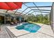 Enclosed pool area with lounge chairs, clear blue water, and views of the serene backyard at 10113 Bell Creek Dr, Riverview, FL 33569