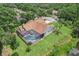 Aerial view of home featuring a screened-in pool, backyard, and mature landscaping at 10113 Bell Creek Dr, Riverview, FL 33569