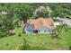 Home featuring a screened-in pool, shed, mature landscaping, and backyard at 10113 Bell Creek Dr, Riverview, FL 33569