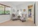 Cozy sitting room features floral chairs, neutral walls, and a window providing ample natural light for a relaxing atmosphere at 10113 Bell Creek Dr, Riverview, FL 33569