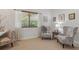 Comfortable sitting room with floral patterned chairs, and a window offering natural light for relaxing or entertaining guests at 10113 Bell Creek Dr, Riverview, FL 33569