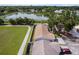 An aerial shot displays the home, its fenced-in backyard and its proximity to a serene pond at 10202 Bellhurst Ct, Tampa, FL 33615