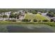 Aerial view showcasing the community field with picturesque lake and surrounding homes at 10202 Bellhurst Ct, Tampa, FL 33615