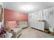 Well-decorated Bedroom with stylish decor, including a crib, dresser, and comfortable chair at 10202 Bellhurst Ct, Tampa, FL 33615