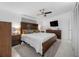 Comfortable bedroom with a ceiling fan, a large wooden bed frame, and soft lighting at 10202 Bellhurst Ct, Tampa, FL 33615