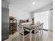 Inviting dining area with table set for six, stainless steel refrigerator, and wine rack at 10202 Bellhurst Ct, Tampa, FL 33615