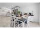 Open concept dining area with stainless appliances, breakfast bar and white cabinetry at 10202 Bellhurst Ct, Tampa, FL 33615