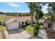 Charming single-story home featuring an attached garage and a well-manicured front yard with mature trees at 10202 Bellhurst Ct, Tampa, FL 33615