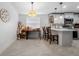 Bright kitchen with white cabinets, quartz countertops, and stainless steel appliances and adjacent eating area at 10202 Bellhurst Ct, Tampa, FL 33615