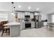 Modern kitchen with stainless steel appliances, white cabinetry, granite countertops, and bright lighting at 10202 Bellhurst Ct, Tampa, FL 33615