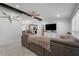 Open-concept living room with decorative beams and view of the adjacent kitchen at 10202 Bellhurst Ct, Tampa, FL 33615