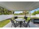 Relaxing covered patio with comfortable seating perfect for outdoor entertaining or peaceful relaxation at 10202 Bellhurst Ct, Tampa, FL 33615