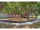 Community playground shaded by mature trees, providing a safe and fun play area at 10202 Bellhurst Ct, Tampa, FL 33615