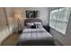 Serene bedroom with a cozy bed, bedside table, and a window with natural light at 10436 White Lake Ct # 10436, Tampa, FL 33626