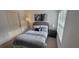 Comfortable bedroom with stylish bedding, window, bedside table, and complementary artwork at 10436 White Lake Ct # 10436, Tampa, FL 33626