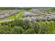 Aerial view of a residential community featuring pond, trees and well-maintained homes at 10580 Gliding Eagle Way, Land O Lakes, FL 34638
