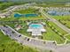 Aerial view of community pool and playground surrounded by lush landscaping and beautiful homes at 10580 Gliding Eagle Way, Land O Lakes, FL 34638