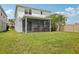 View of the backyard and screened-in lanai, perfect for enjoying the outdoors at 10580 Gliding Eagle Way, Land O Lakes, FL 34638