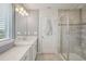 This bathroom features a sleek vanity, modern lighting, and a glass-enclosed shower at 10580 Gliding Eagle Way, Land O Lakes, FL 34638