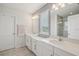 This bathroom features a double sink vanity, large mirrors, and a window for natural light at 10580 Gliding Eagle Way, Land O Lakes, FL 34638