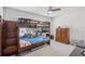 Cozy bedroom featuring bunk beds, a wooden dresser, and natural lighting from the window at 10580 Gliding Eagle Way, Land O Lakes, FL 34638