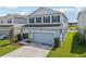 Charming two-story home boasts a two car garage, well manicured lawn and serene pond view at 10580 Gliding Eagle Way, Land O Lakes, FL 34638
