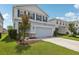 Two-story home featuring blue shutters, a two-car garage, and landscaping at 10580 Gliding Eagle Way, Land O Lakes, FL 34638