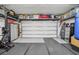 This garage is equipped with shelving and a workout area complete with rowing machine and punching bag at 10580 Gliding Eagle Way, Land O Lakes, FL 34638